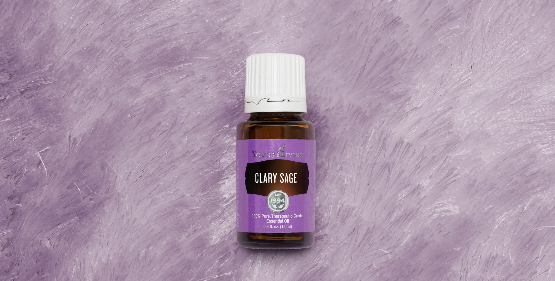 clary sage essential oil on a purple background 