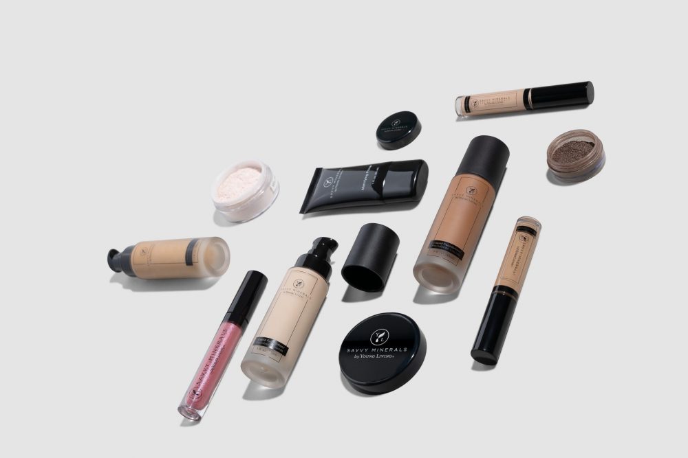 foundation, concealer, powder, and other makeup products arranged on a clean background