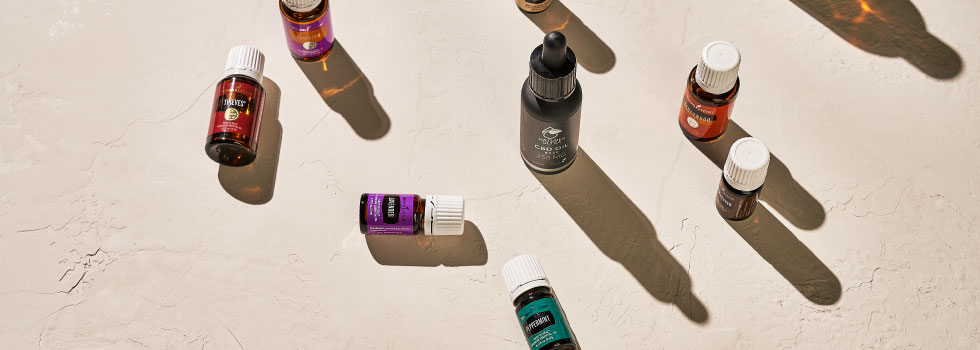 CBD Oil Base surrounded by essential oils - Young Living Essential Oils
