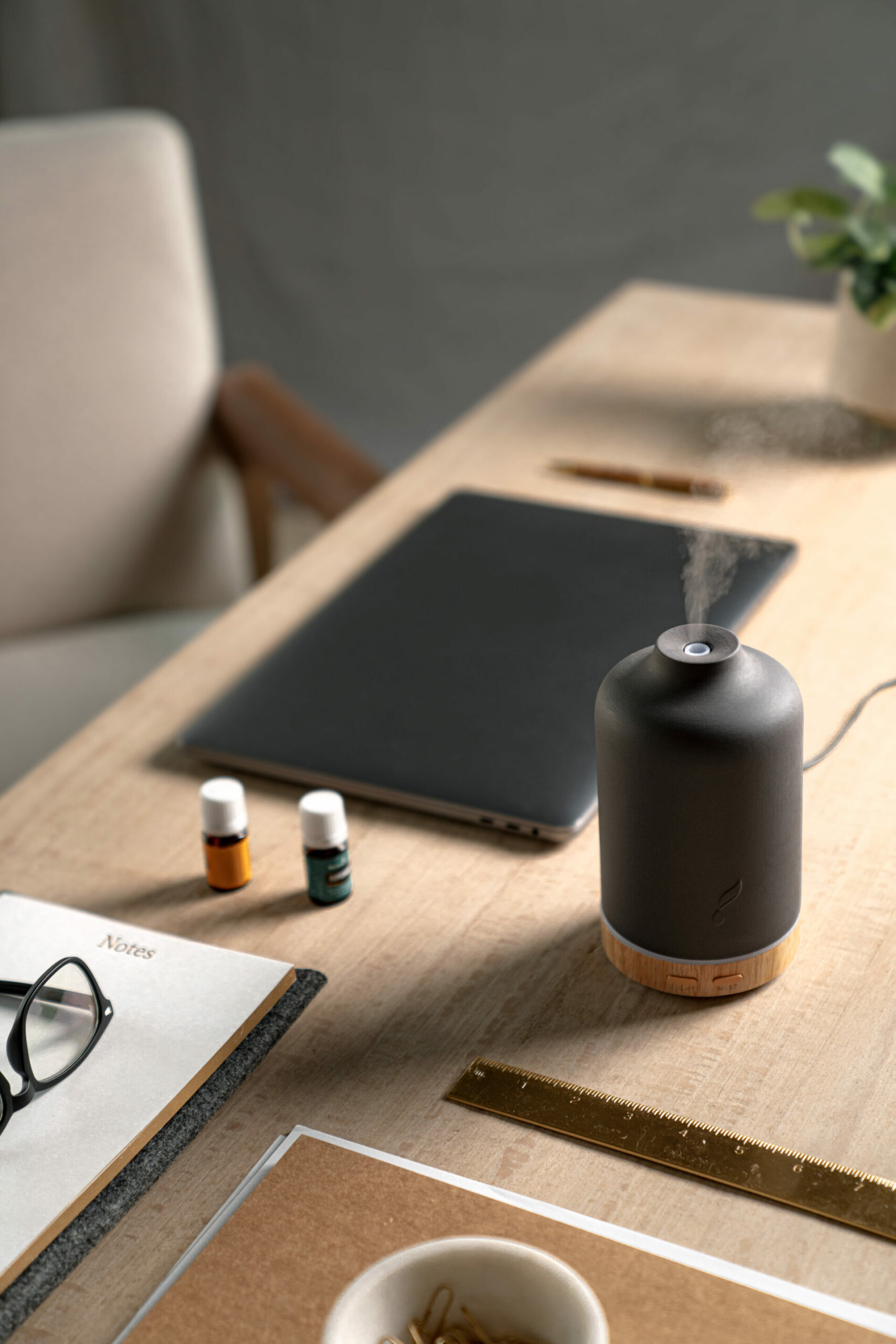 Ember diffuser sitting on desk with office supplies and essential oils - Young Living Lavender Life blog 