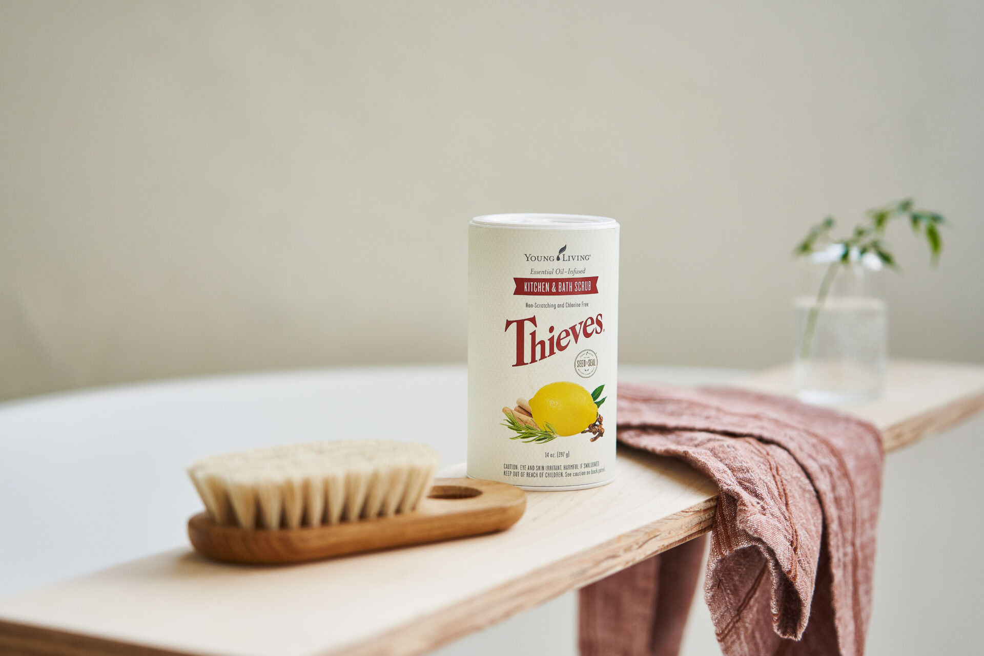 Thieves Kitchen & Bath Scrub sitting on bath tray with cloth and brush - Young Living Lavender Life blog 