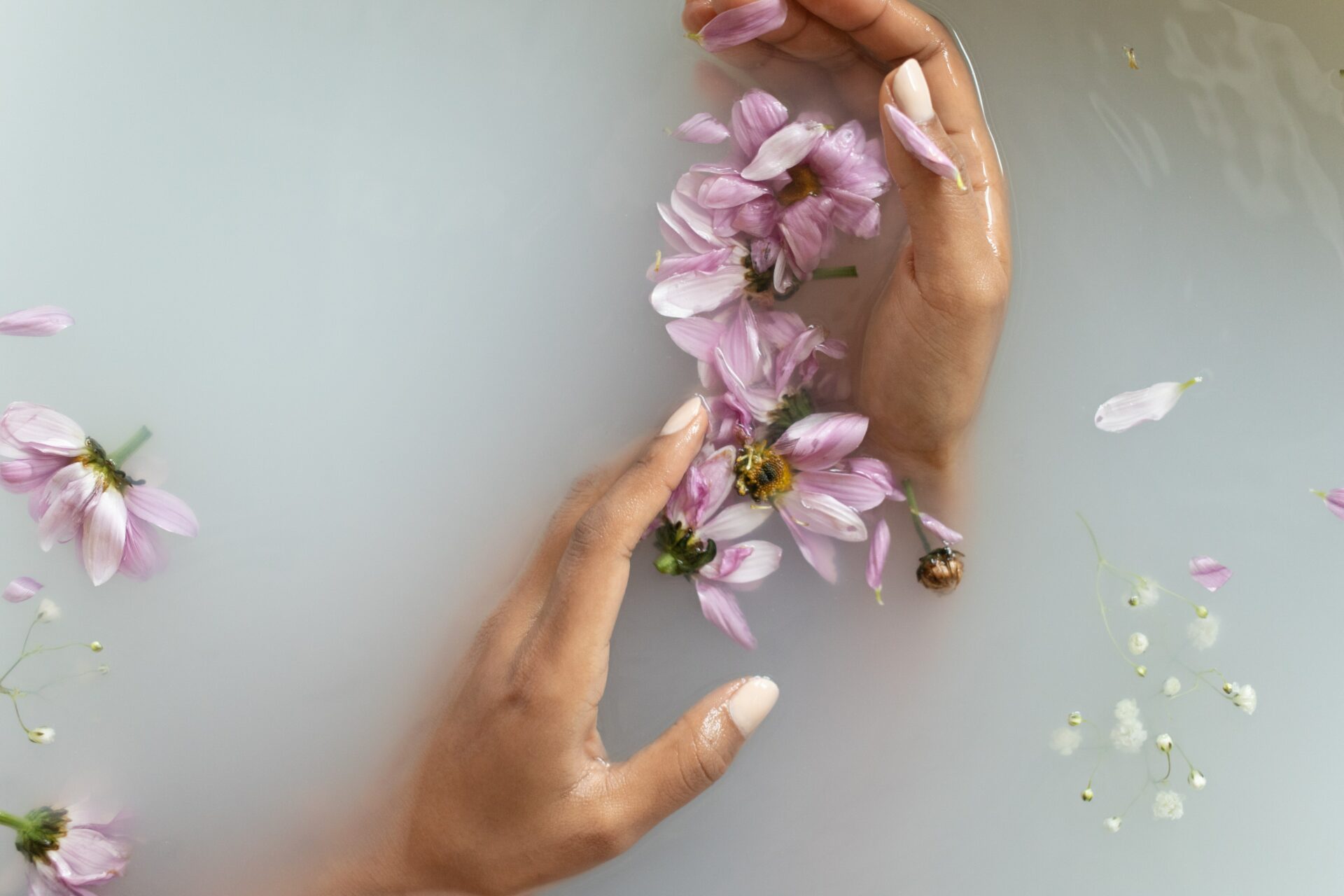 Hands in bath with flower petals - Young Living Lavender Life blog 