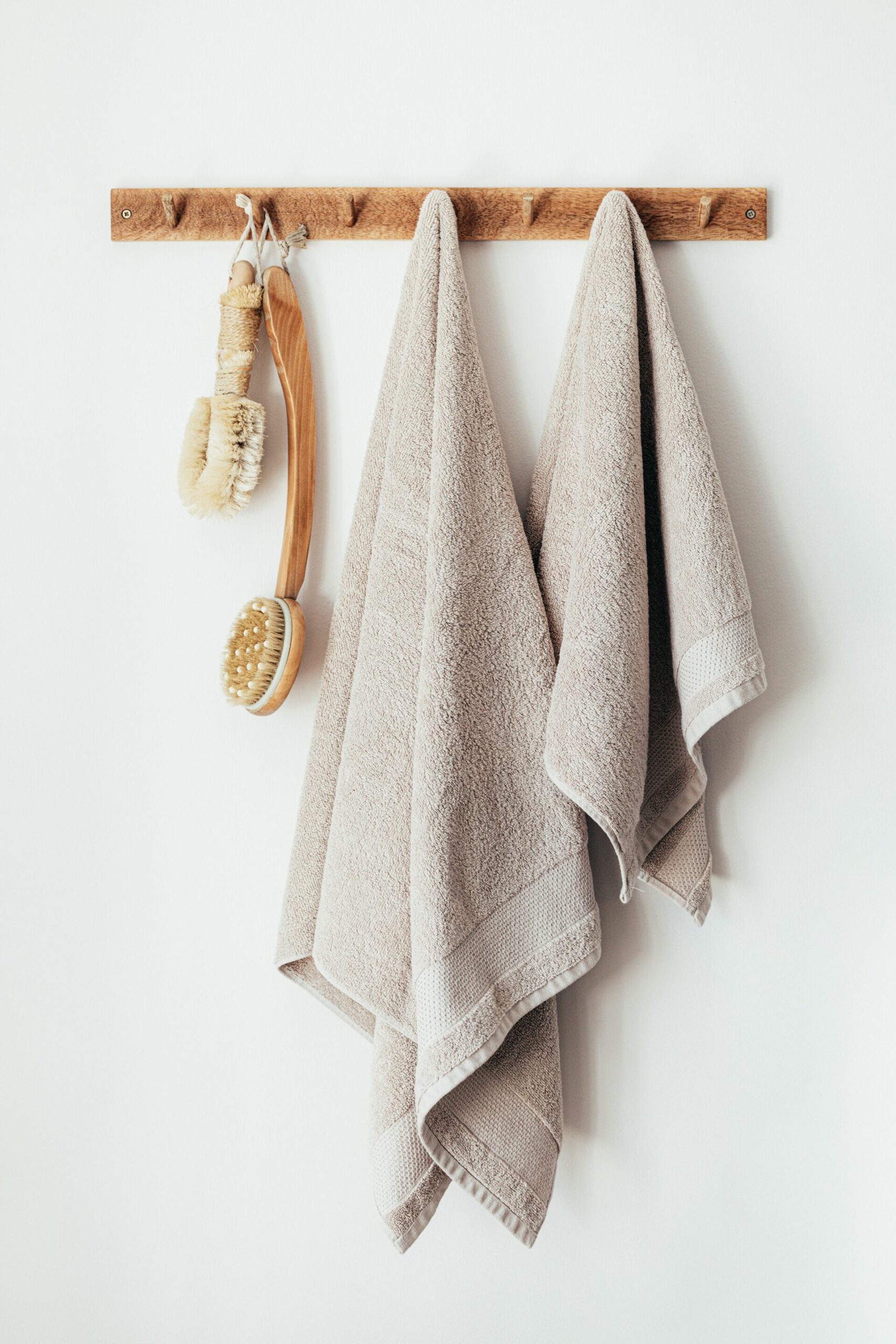 Wooden hanger with bath towels and body brushes hanging - Young Living Lavender Life blog