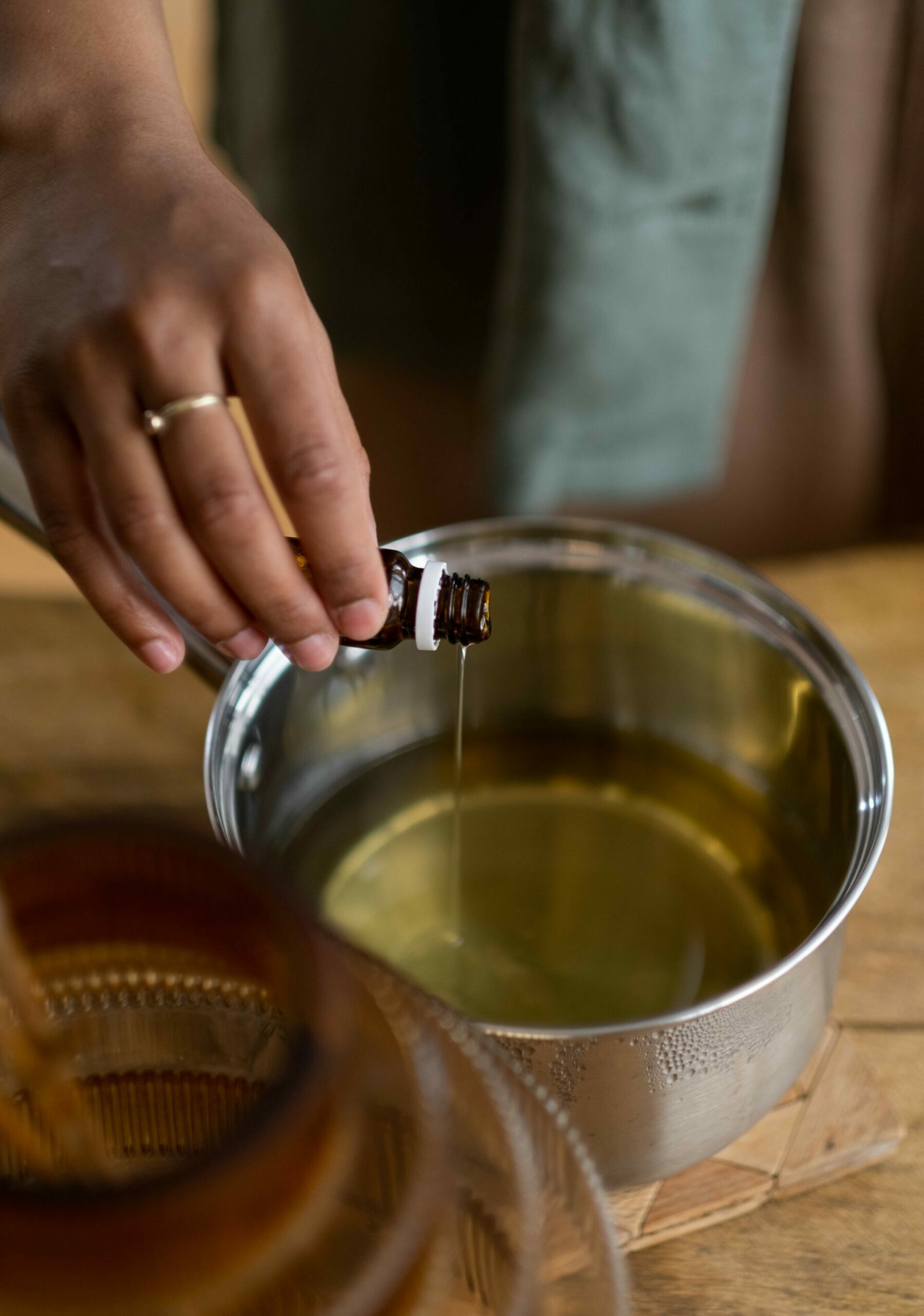 Pouring essential oils into a kitchen pot - Young Living Lavender Life blog