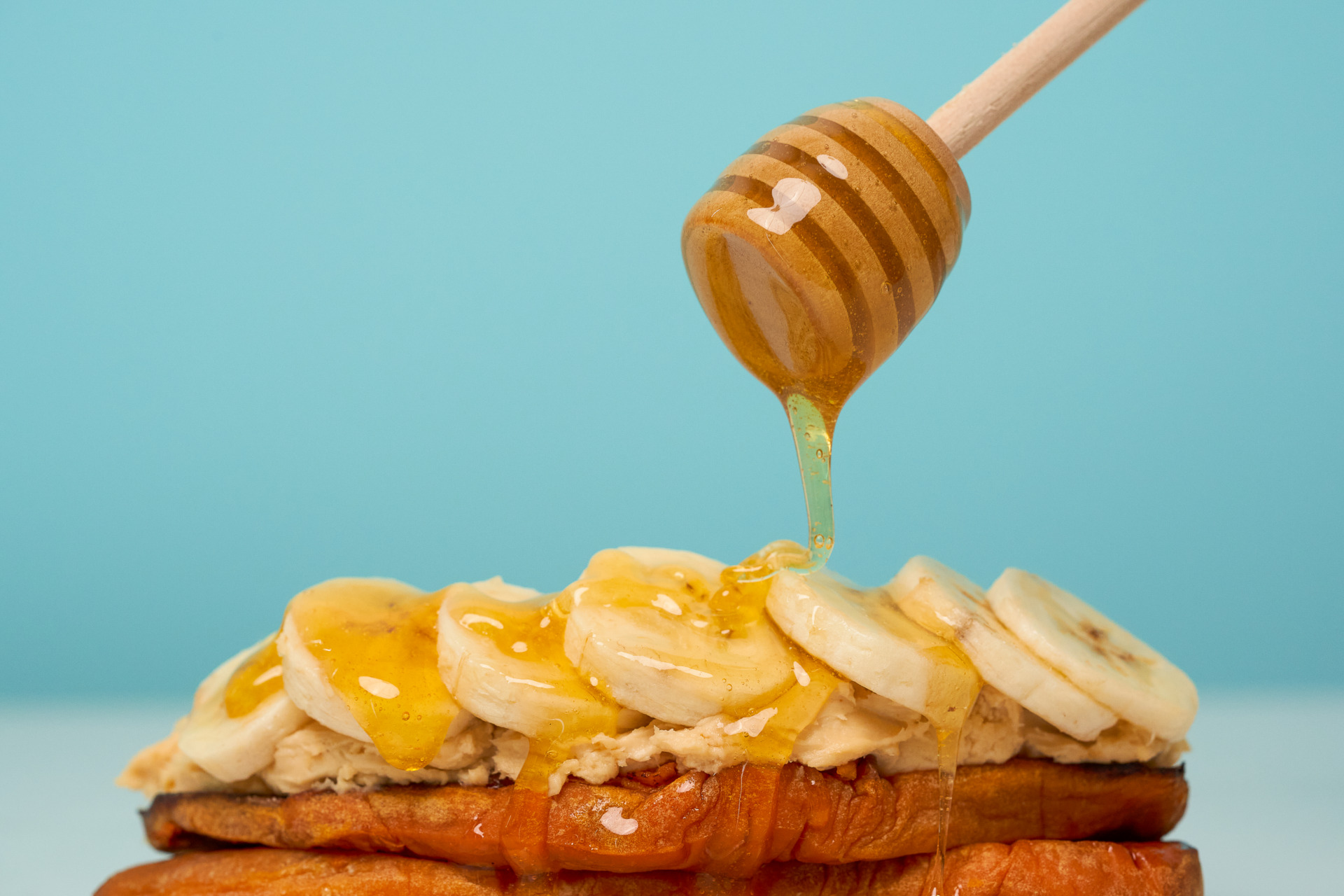 Sweet potato toast with banana, peanut butter cream cheese topping, and honey drizzle - Young Living Lavender Life Blog 