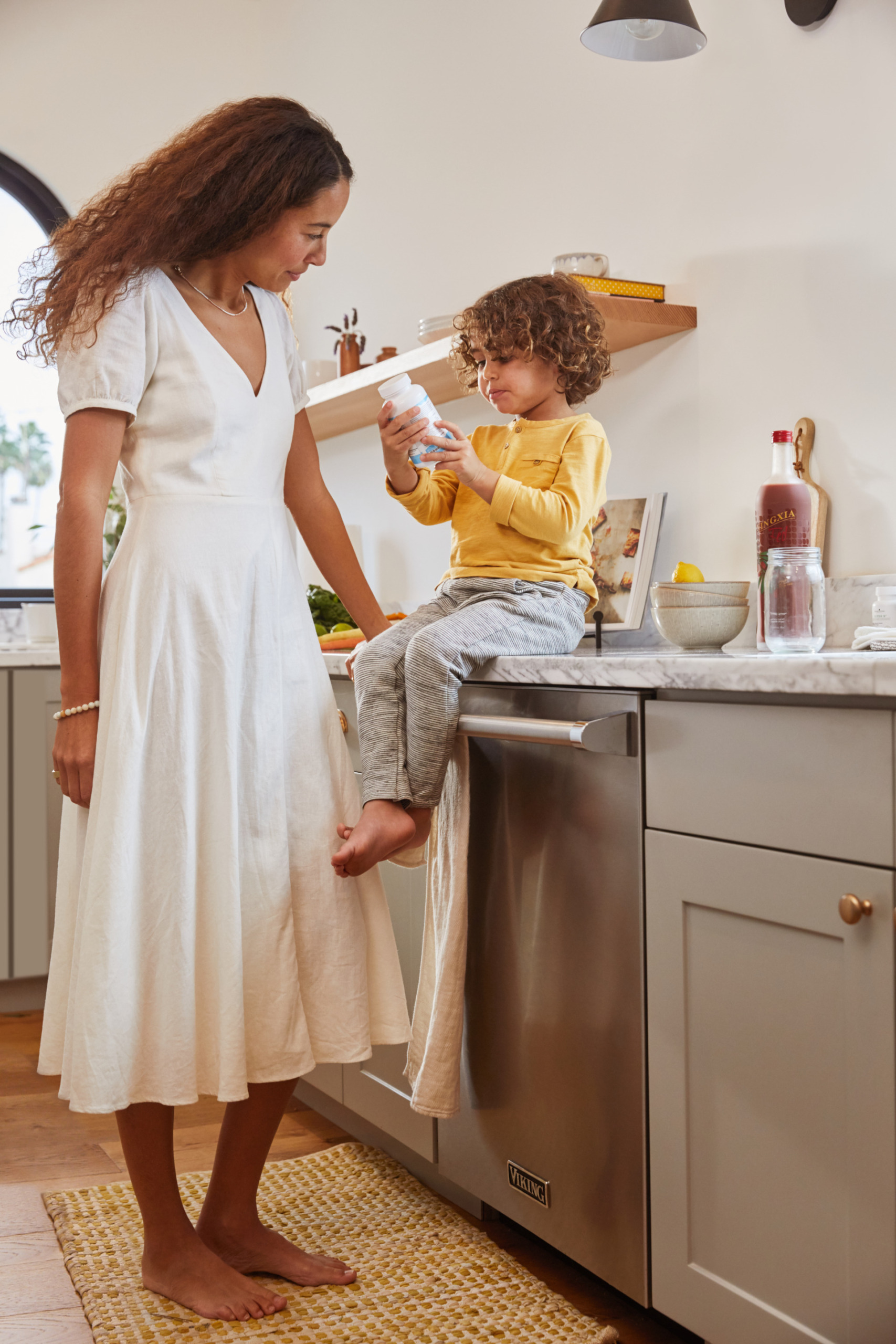 Woman and her son in kitchen with supplements
