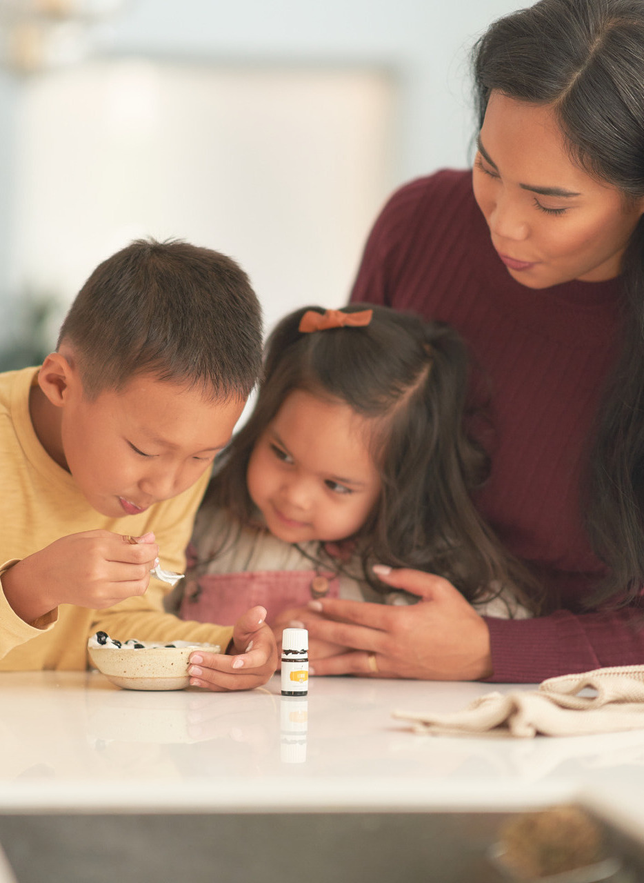 Mom and kids making Vitality essential oil-infused breakfast - Young Living Lavender Life Blog 