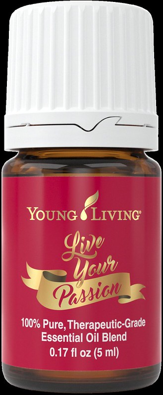 A bottle of Young Living Live Your Passion essential oil blend (red with gold lettering).