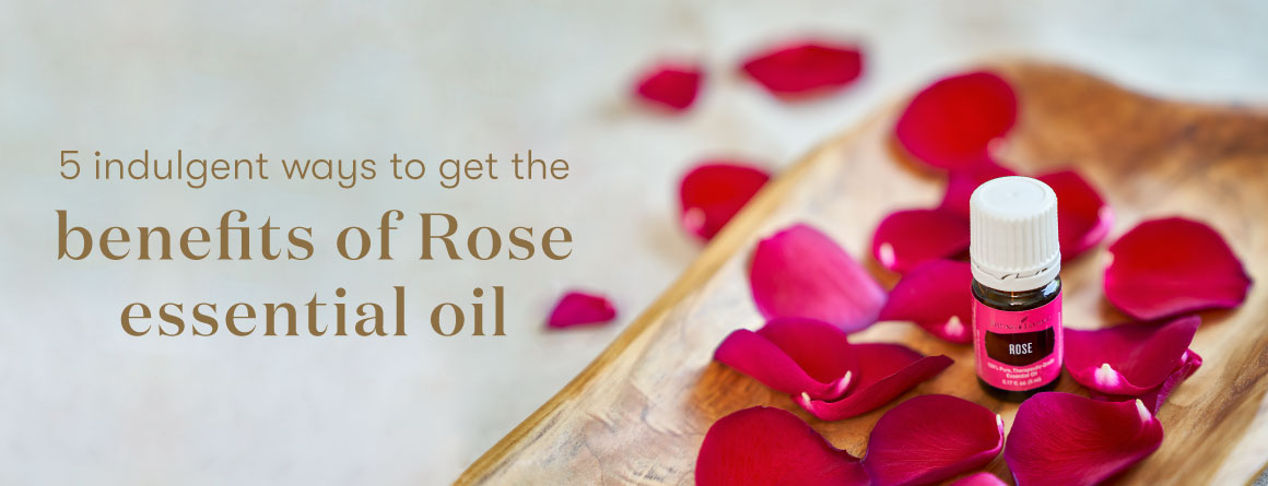Rose Essential oil surrounded by rose petals