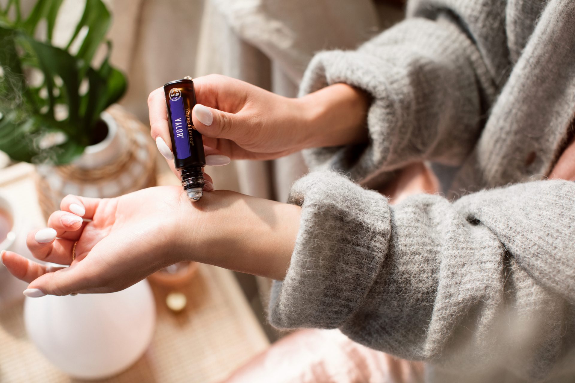 Young Living essential oil Valor roller being applied to wrist