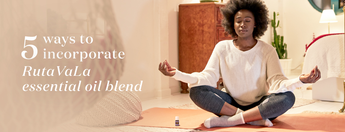 Girl meditating with Young Living RutaVala essential oil blend