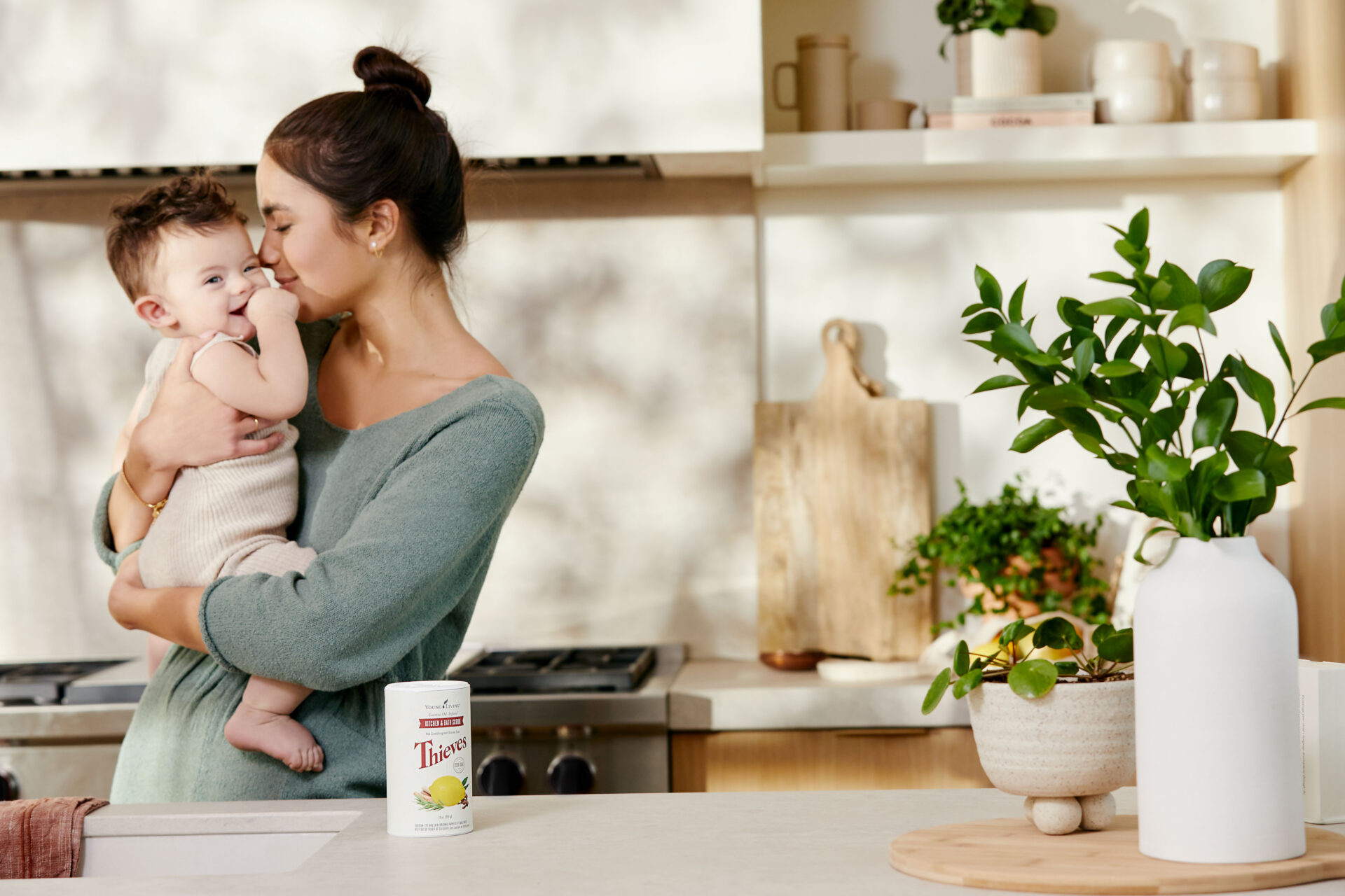 Mom & baby in kitchen with Thieves Kitchen & Bath Scrub on display - Young Living Lavender Life Blog