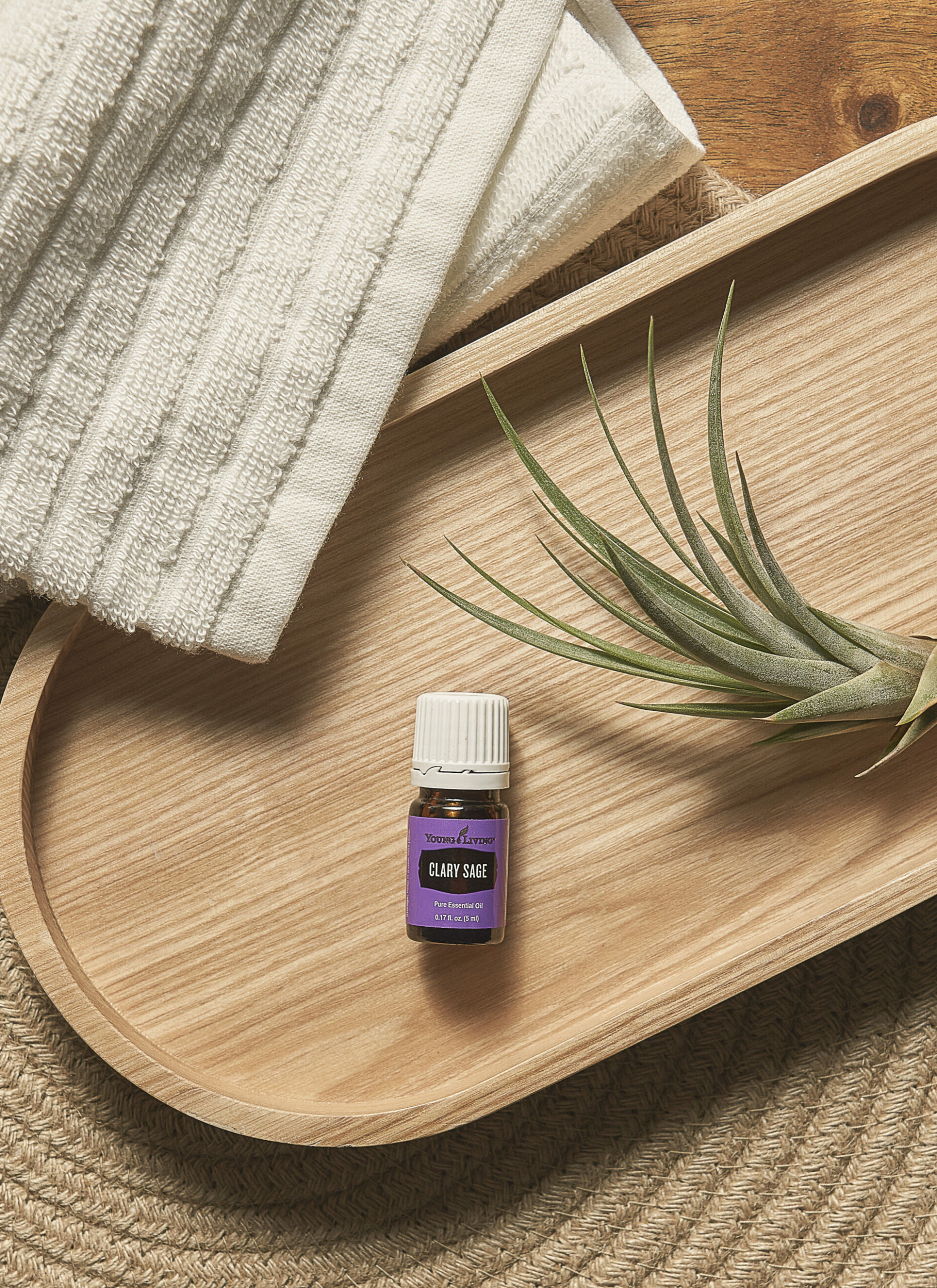 Clary Sage Essential Oil sitting on wooden tray - Young Living Lavender Life Blog 