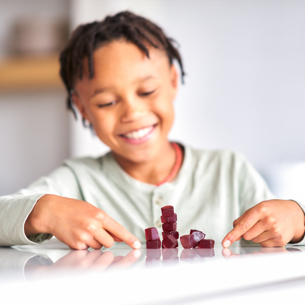 young child stacking immugummies